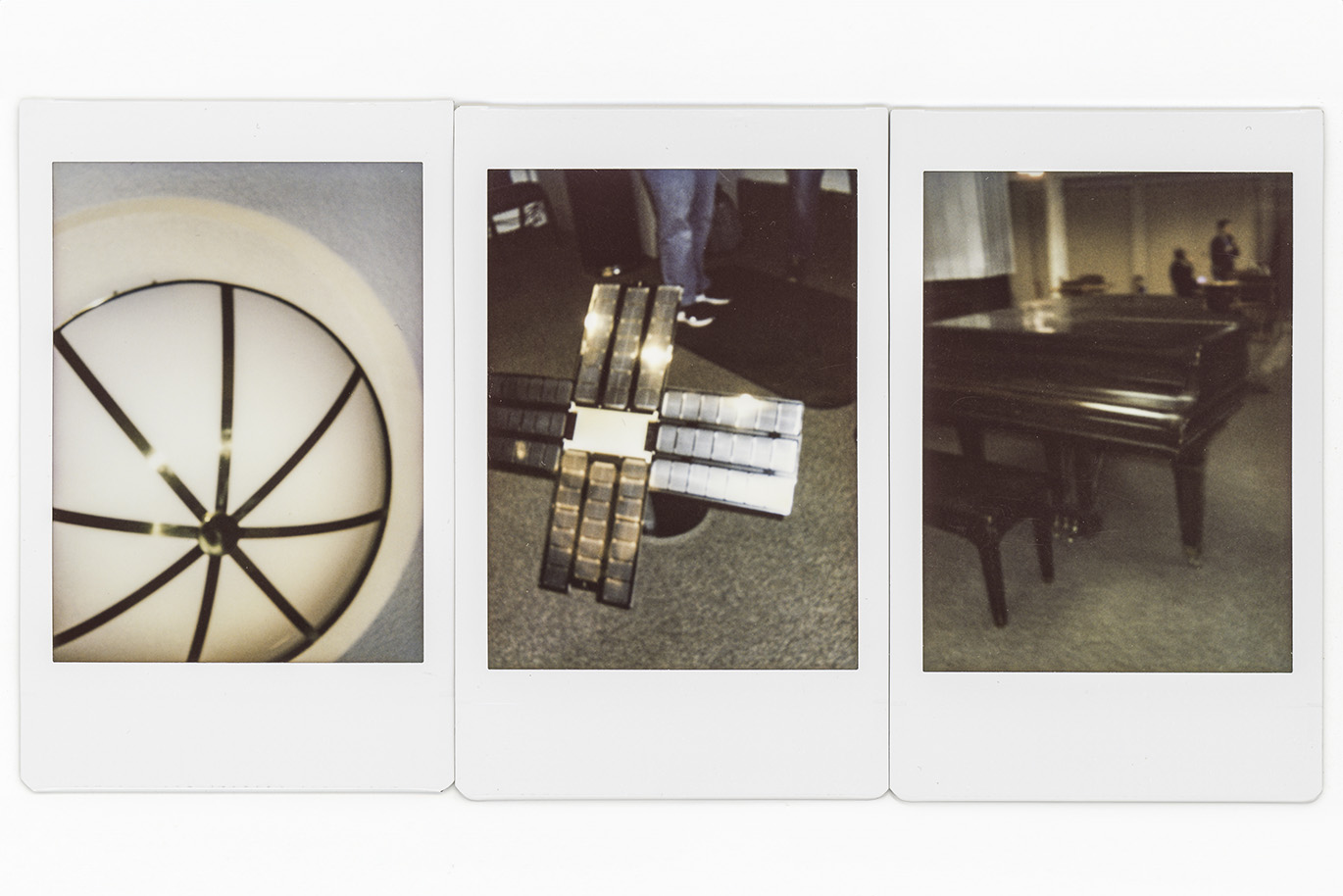 Set of three scanned polaroid photos showing a light fixture, satellite like object and a piano.