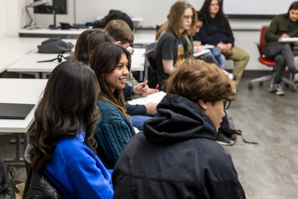 Portrait of young college female student smiling while attending class.