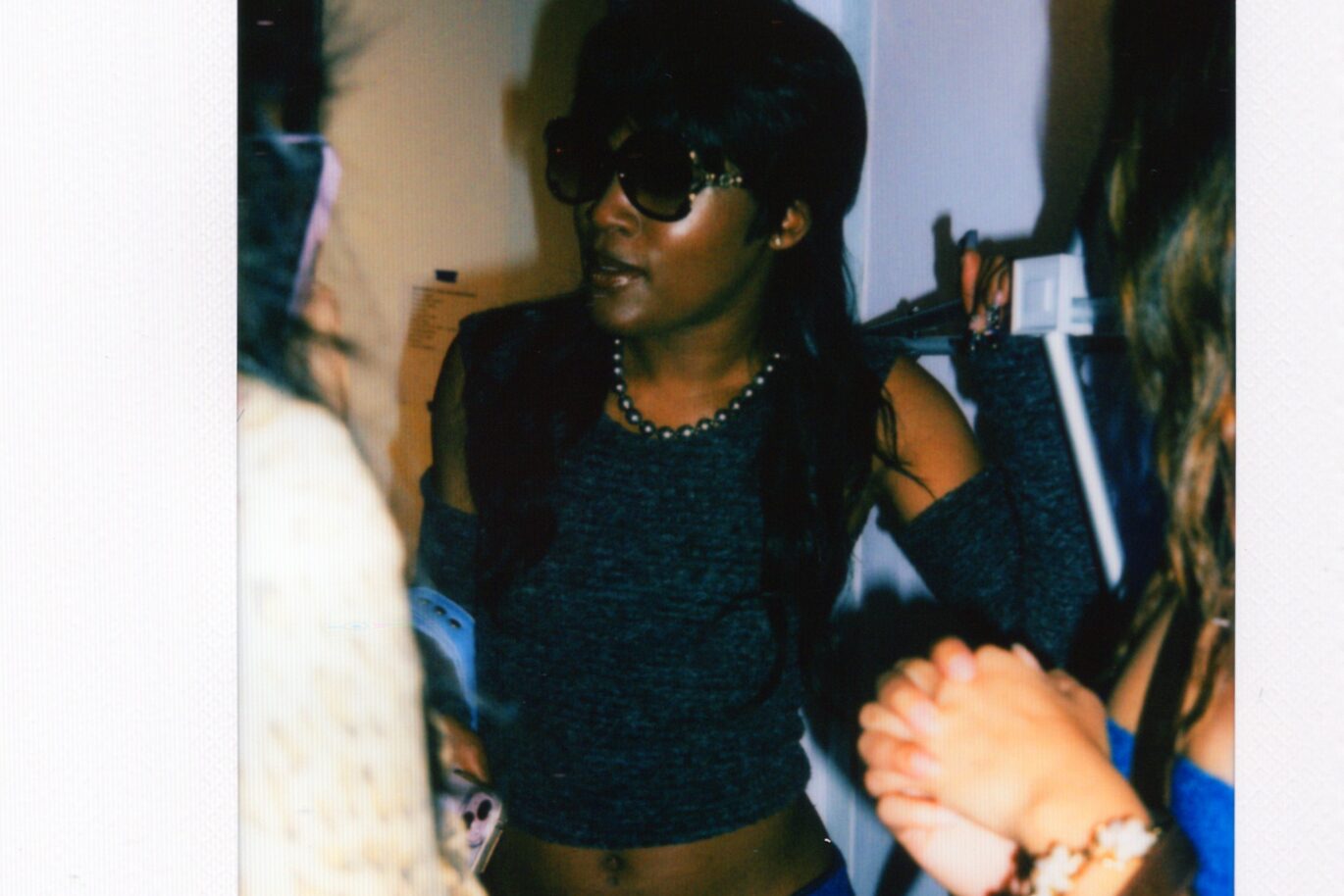 Woman poses in front other students before Fashion Show