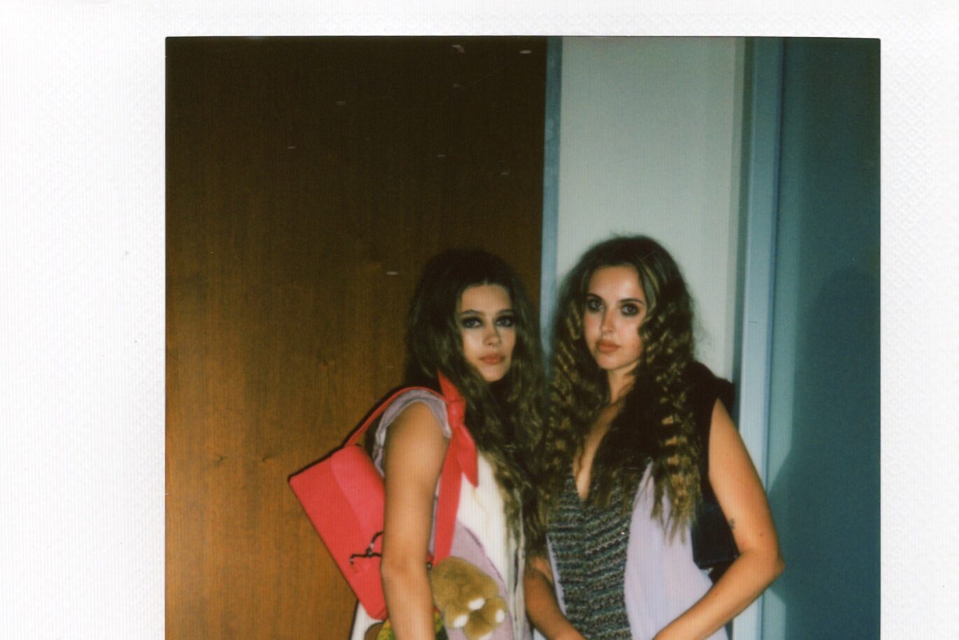 Two pose in front of camera to prepare for fashion show