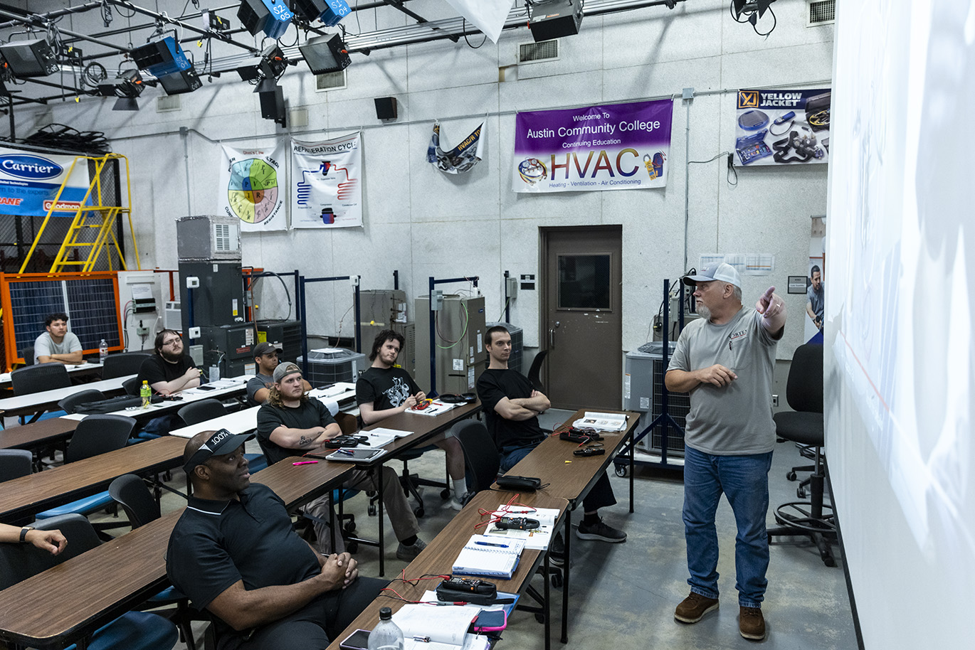 College instructor teaches a lecture inside a classroom.