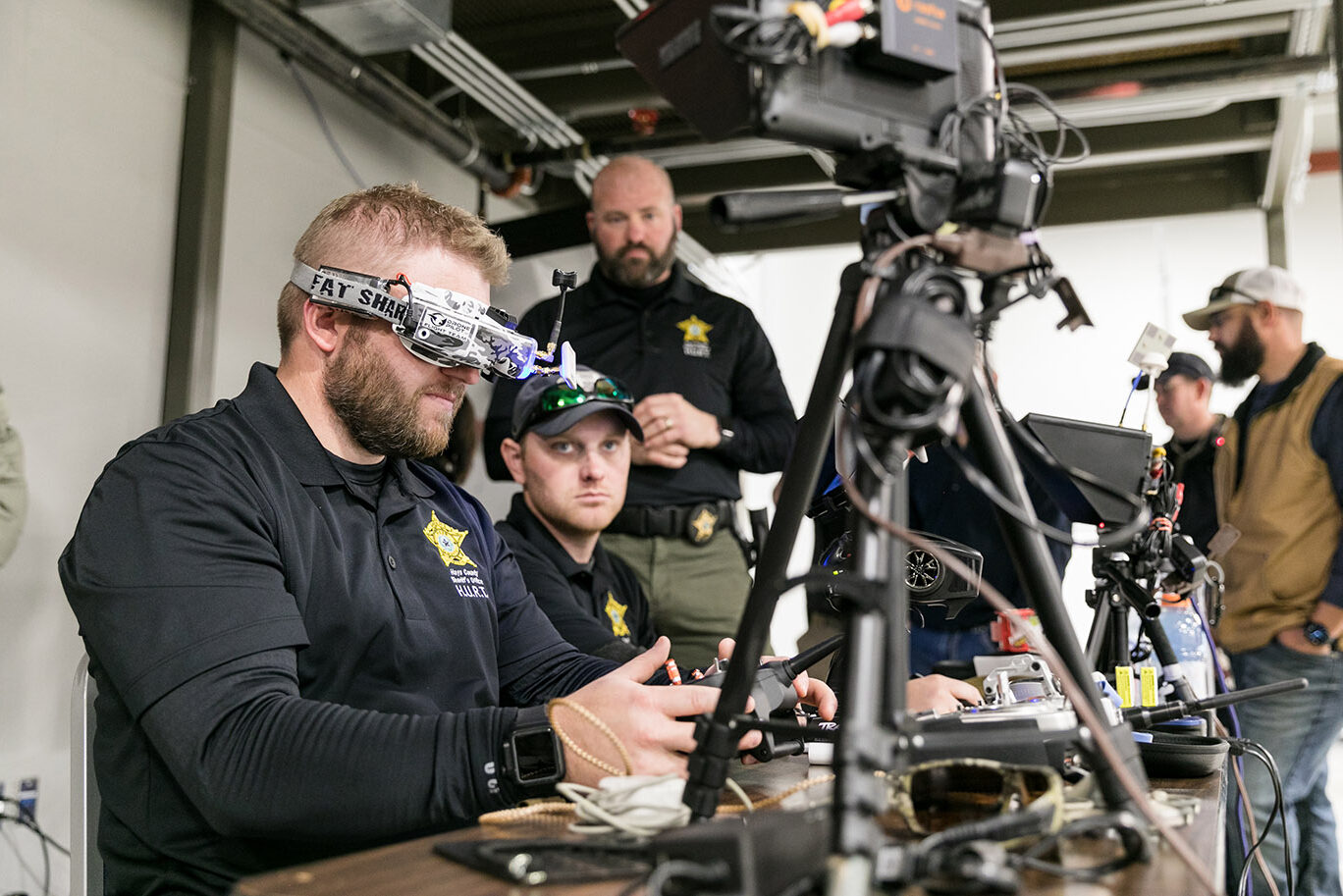 A mean wearing an electronic headset controls a drone during a tactical training exercise.