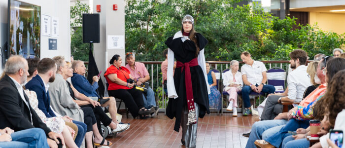 Model walks down the runway at Visions Fashion Show