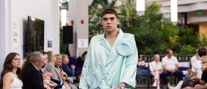 Model walks down the runway at Visions Fashion Show