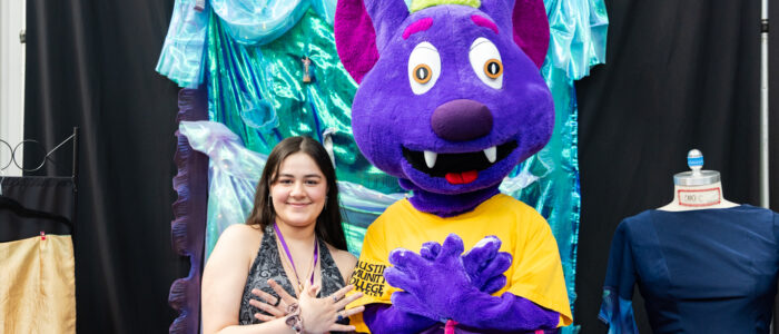 Designer poses with R.B. the Riverbat