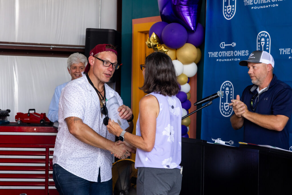 Members of the first cohort of automotive and HVAC trainees with The Other Ones Foundation (TOOF) are recognized during a graduation ceremony on Wednesday, Aug. 6, 2025, at the TOOF training center in Austin, Texas. The foundation’s Vocational Training Program - developed in partnership with Austin Community College District, Workforce Solutions Capital Area, and philanthropist John Paul DeJoria - equips individuals exiting homelessness with hands-on training and direct pathways to employment in high-demand fields.