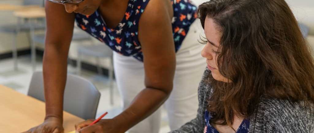 Instructor helps a student