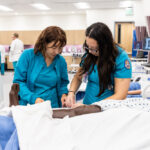 ACC Professional Nursing - Associates Degree Nursing Mobility Track cohort students practice skills during simulated clinical activities on Wednesday, July 26, 2023, inside the ACC Regional Simulation Center at the Highland Campus.