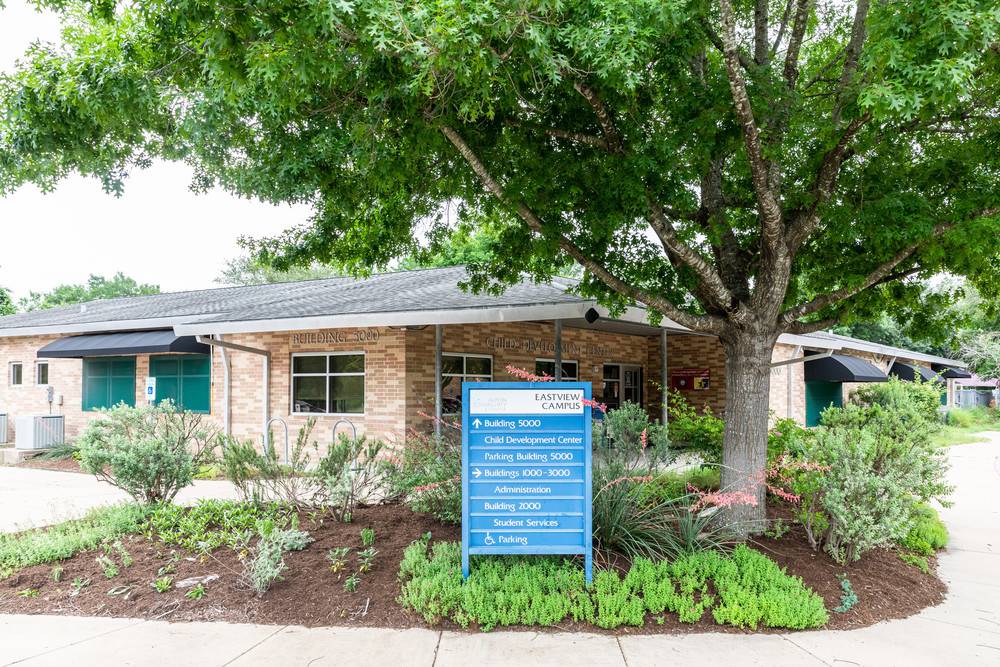 Front entrance of the children's lab school, featuring welcoming doors and a well-maintained pathway leading inside.  
